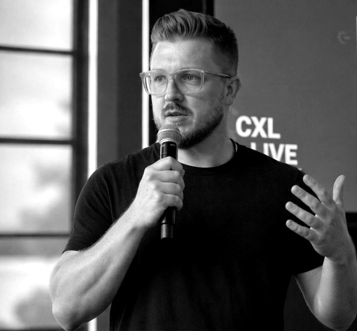 Mitchell Conquer speaking on stage